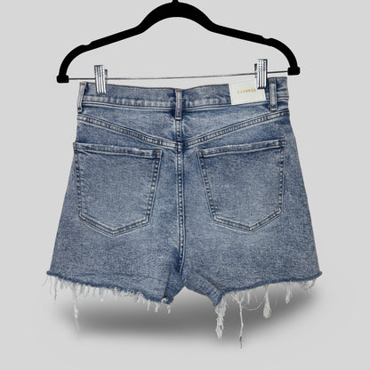 Blue denim shorts on a hanger against a gray background